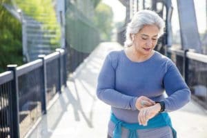 Mature Mexican Woman using fitness tracker